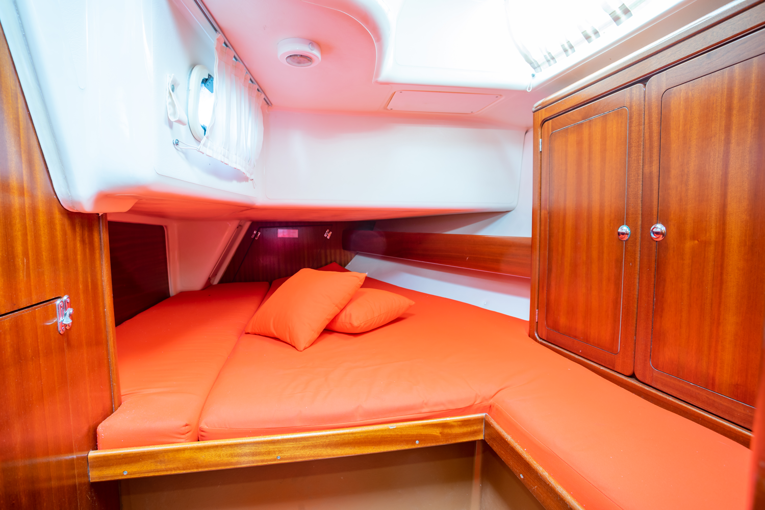 Double berth cabin with orange bedding