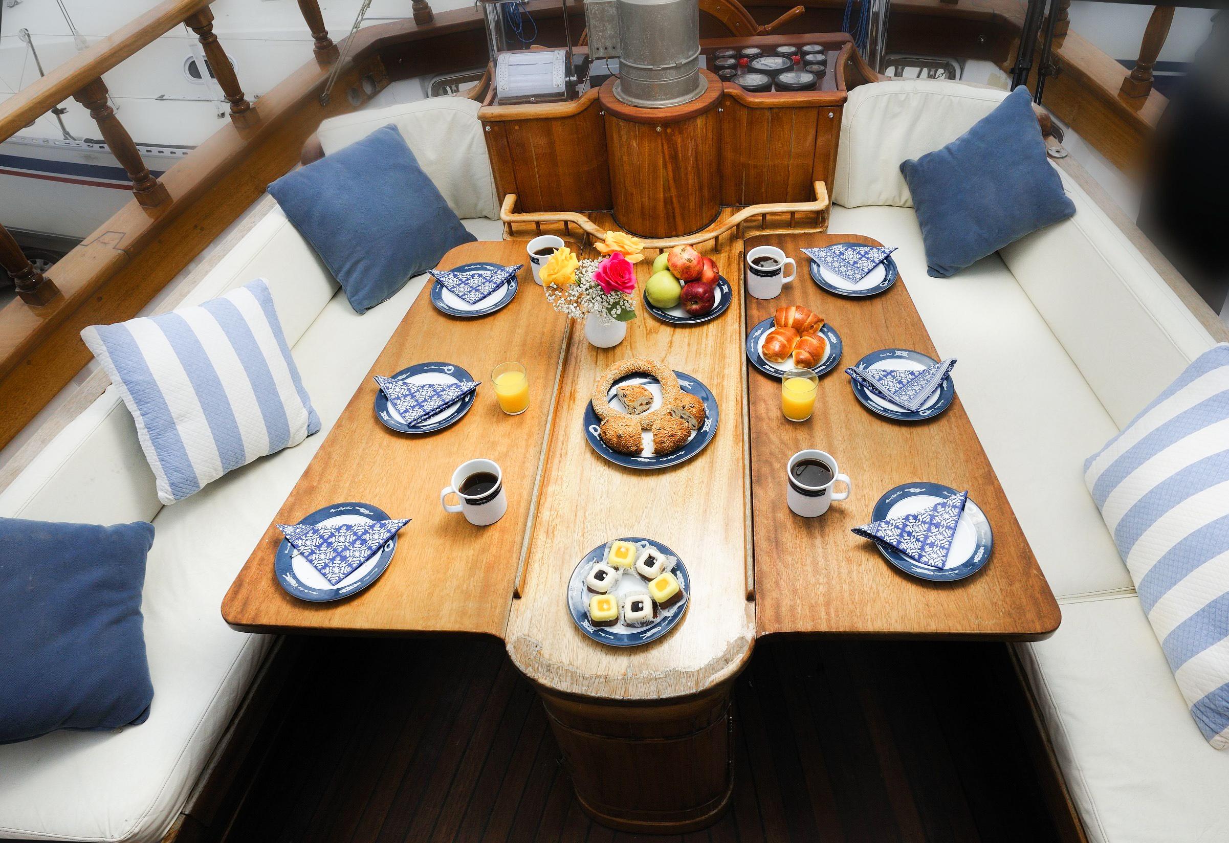 Dining area set up for a meal with blue and white tableware and wooden table